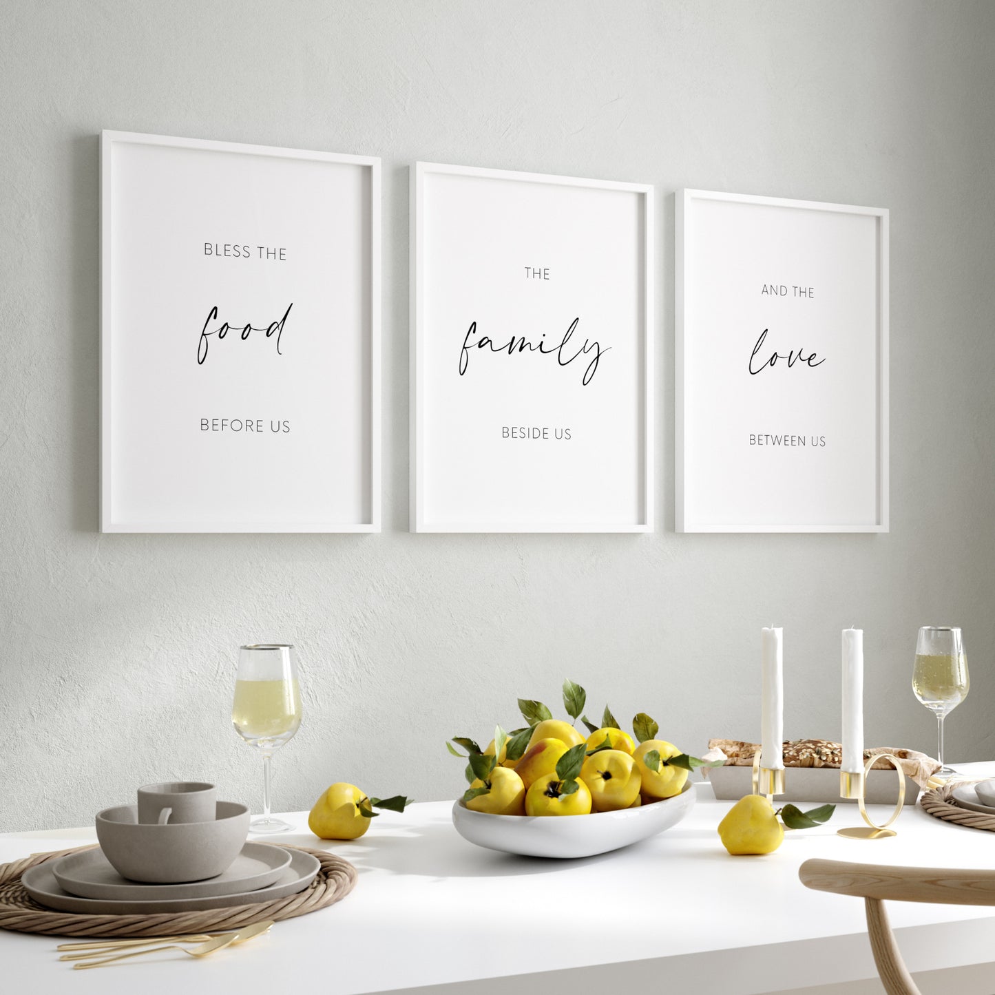 Set of 3 portrait prints displayed in black frames and in a dining room setting. Text across the 3 reads: Bless the food before us the family beside us and the love between us. The words food, family and love and displayed prominently.