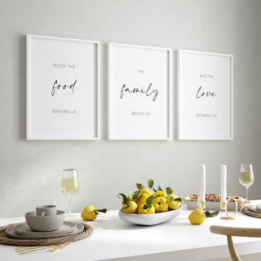 Set of 3 portrait prints displayed in black frames and in a dining room setting. Text across the 3 reads: Bless the food before us the family beside us and the love between us. The words food, family and love and displayed prominently.