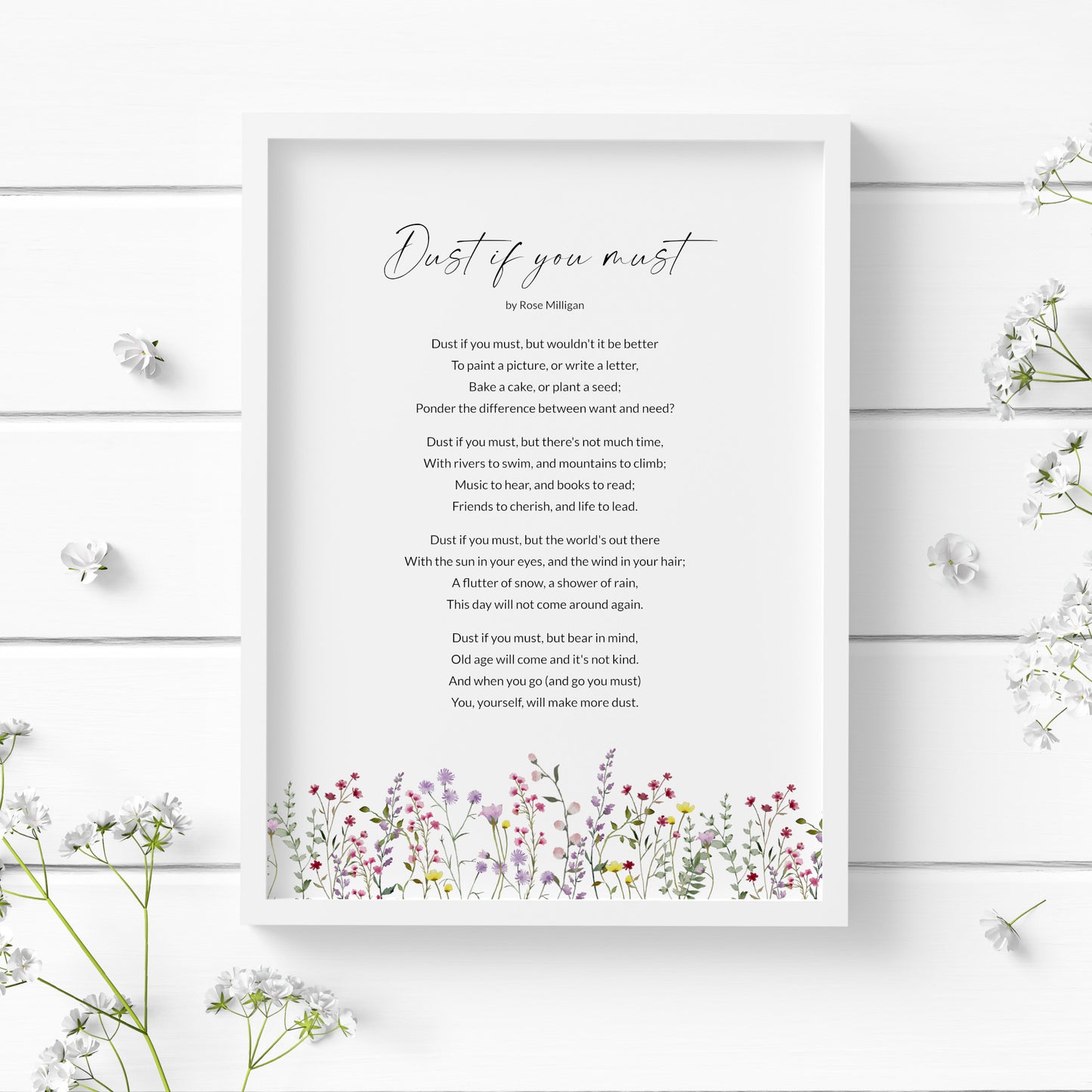 Single portrait typography print featuring the poem Dust If You Must by Rose Milligan. The title is in an elegant script font, with the body text in a crisp sans serif font. Text is black on a white background. The print is finished with a lower border of brightly coloured wildflowers.