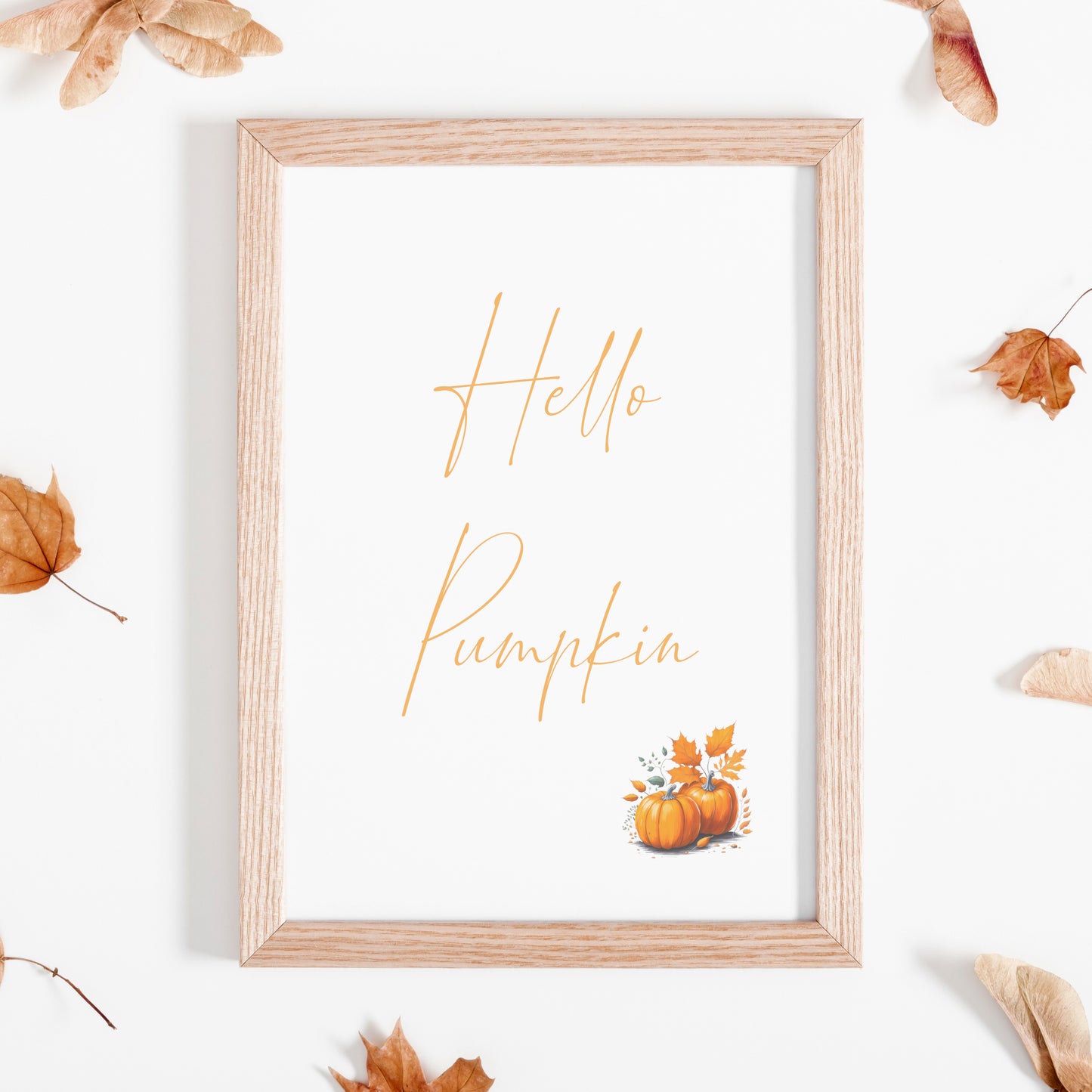 Single portrait typography print featuring the following text: Hello Pumpkin. Text is in an autumnal shade of orange and in a contemporary script font. The print is complemented by a small illustration of pumpkins to the bottom right.