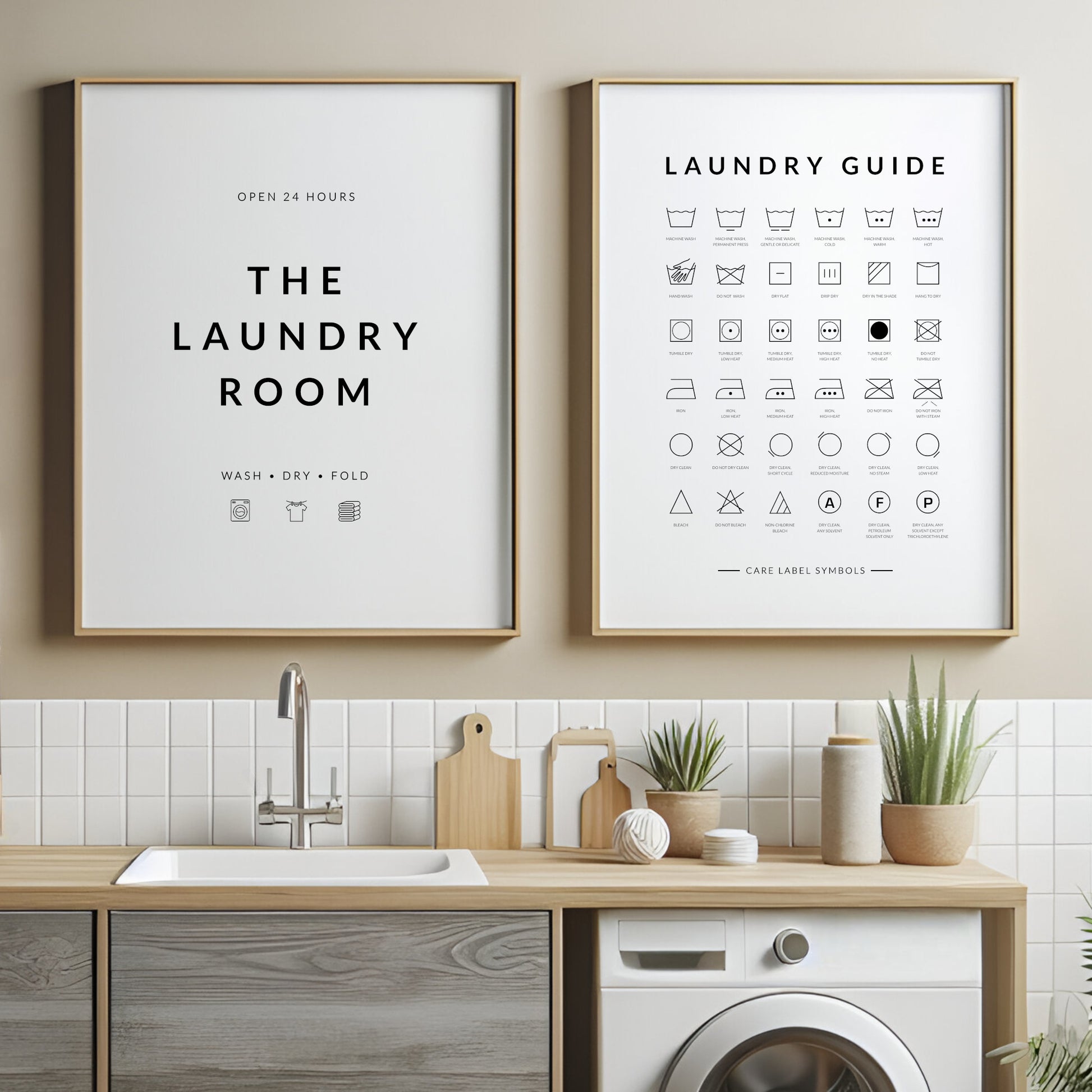 Set of 2 portrait prints. Print 1 reads: Open 24 Hours The Laundry Room Wash Dry Fold. Print 2 is titled Laundry Guide and shows laundry care symbols and their meanings. Print is black on a white background. Styling is modern.