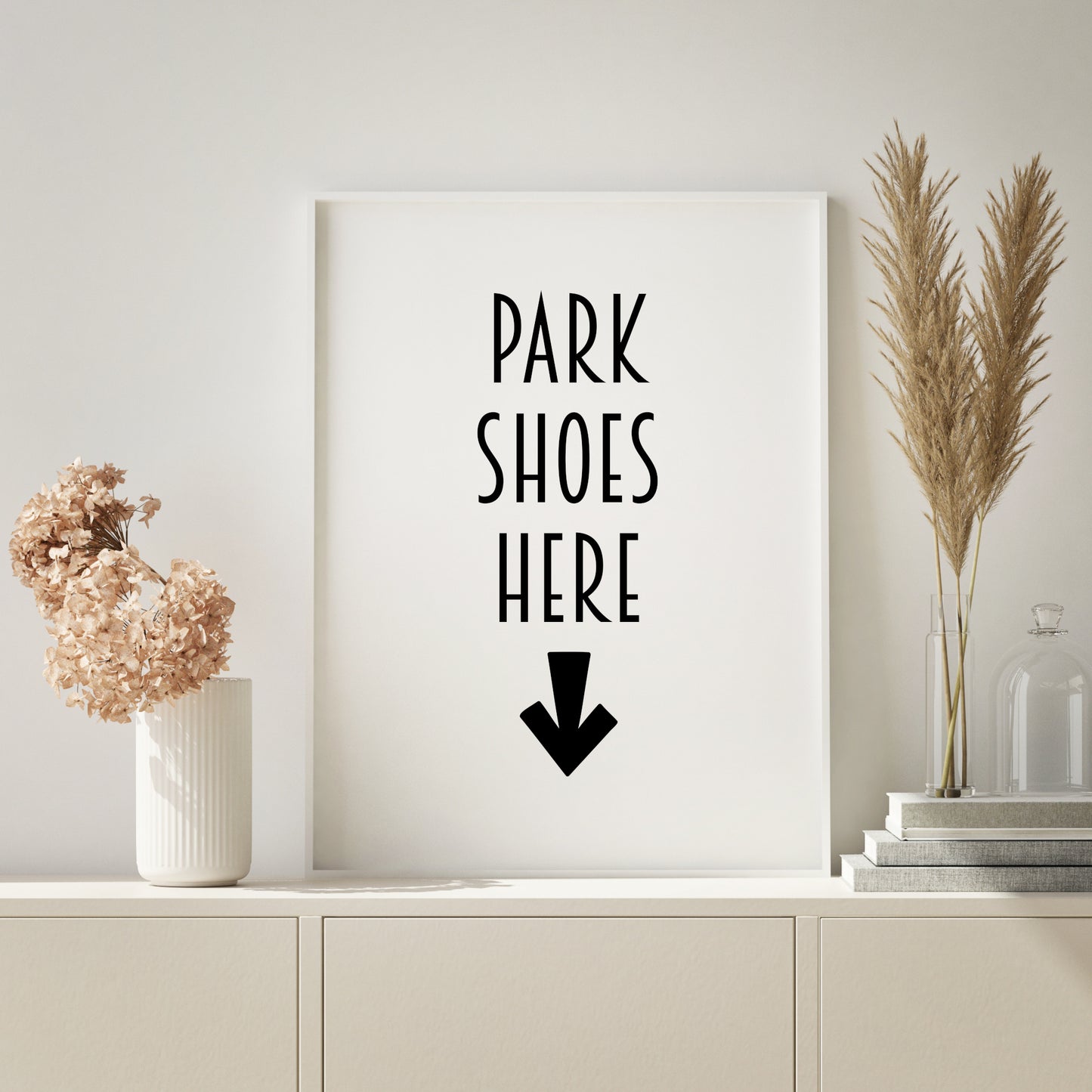 Single portrait tyopgraphy print. Text reads: Park Shoes Here. Text is in an upper case art deco style font. A bold downward-pointing arrow is positioned below the text. Text and imagery are black on a white background. Styling is modern.