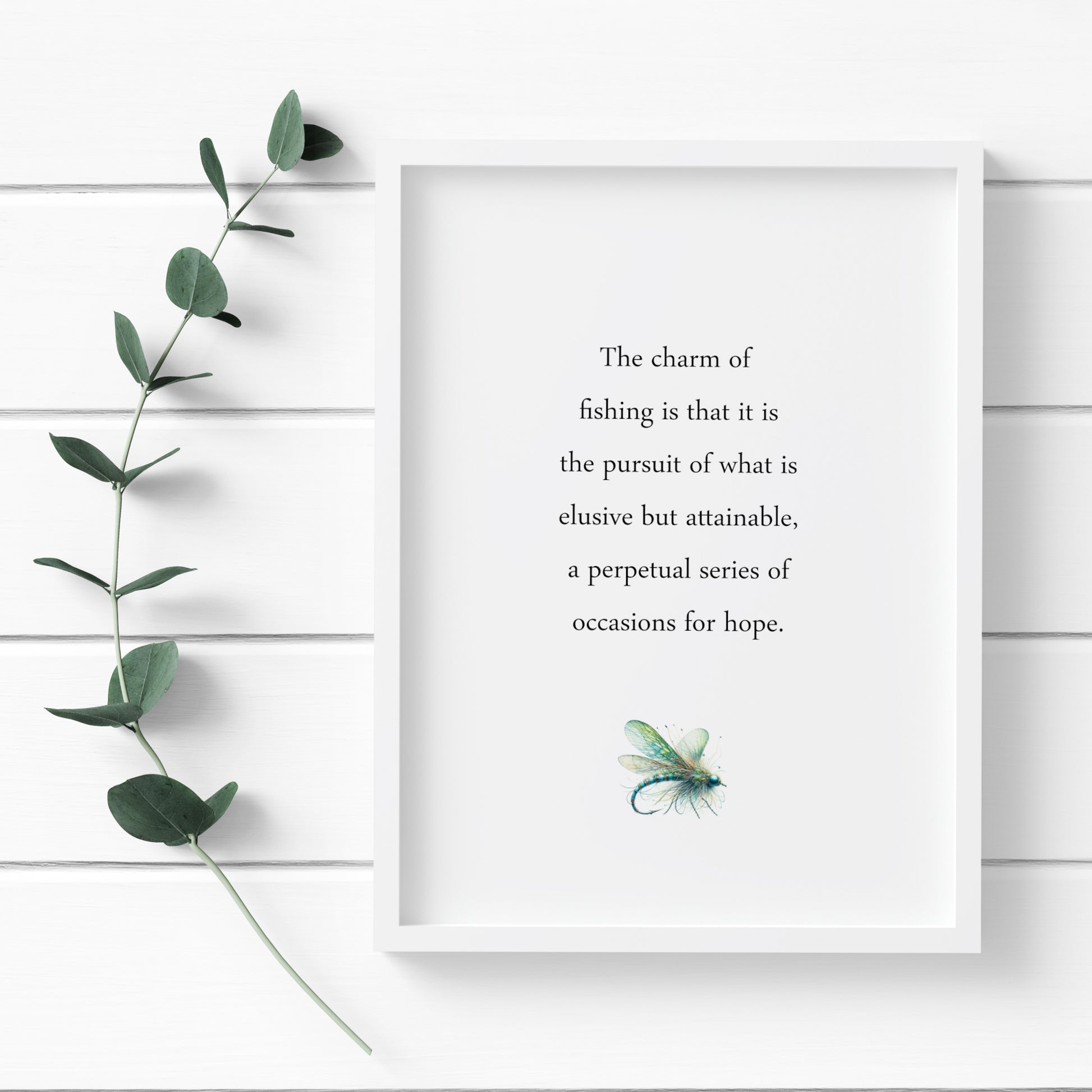 Single portrait typography print featuring a John Buchan quote about the charm of fishing. Text is black on a white background and in classic sentence case serif font. A delicate illustration of a fishing lure is positioned below in blues and greens.