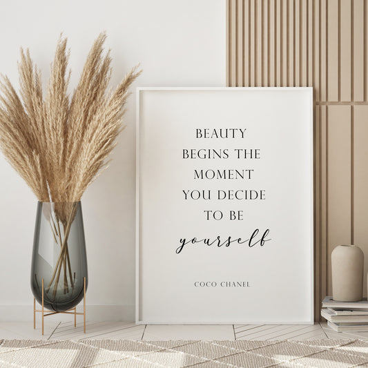 Single portrait typography print featuring the following quote from Coco Chanel: Beauty begins the moment you decide to be yourself. Text is in a formal serif upper case font, with the exception of the word "yourself", which is shown in an elegant script font. The text includes an attribution to Coco Chanel. Text is black on a white background.