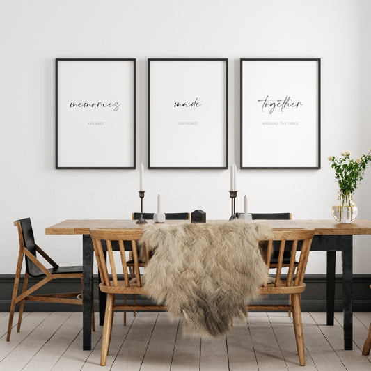 Set of 3 typography prints shown framed in a dining room setting. Text across the 3 reads Memories are best made gathered together around the table, with the words memories made together displayed prominently in an elegant script font.