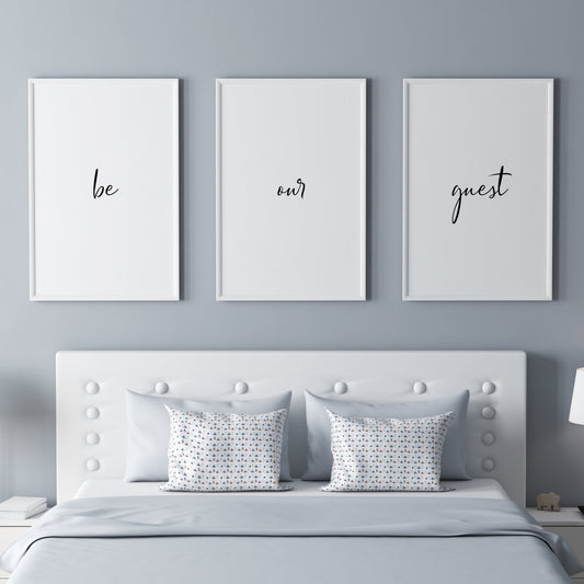 Set of 3 portrait typography prints. Text reads: be our guest. The text is distributed across the 3 prints, with one word on each. All text is in a striking script font, black on a white background.