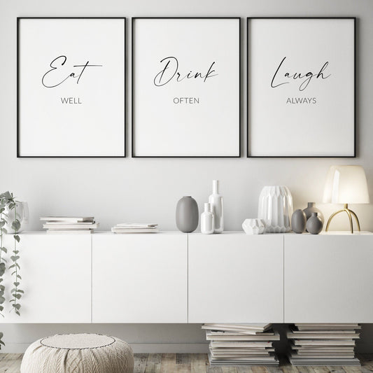 Set of 3 portrait typography prints. Print 1 reads: Eat well. Print 2 reads: Drink Often. Print 3 reads: Laugh Always. The words Eat, Drink and Laugh are displayed prominently in an elegant script font. The perfect dining room wall art!