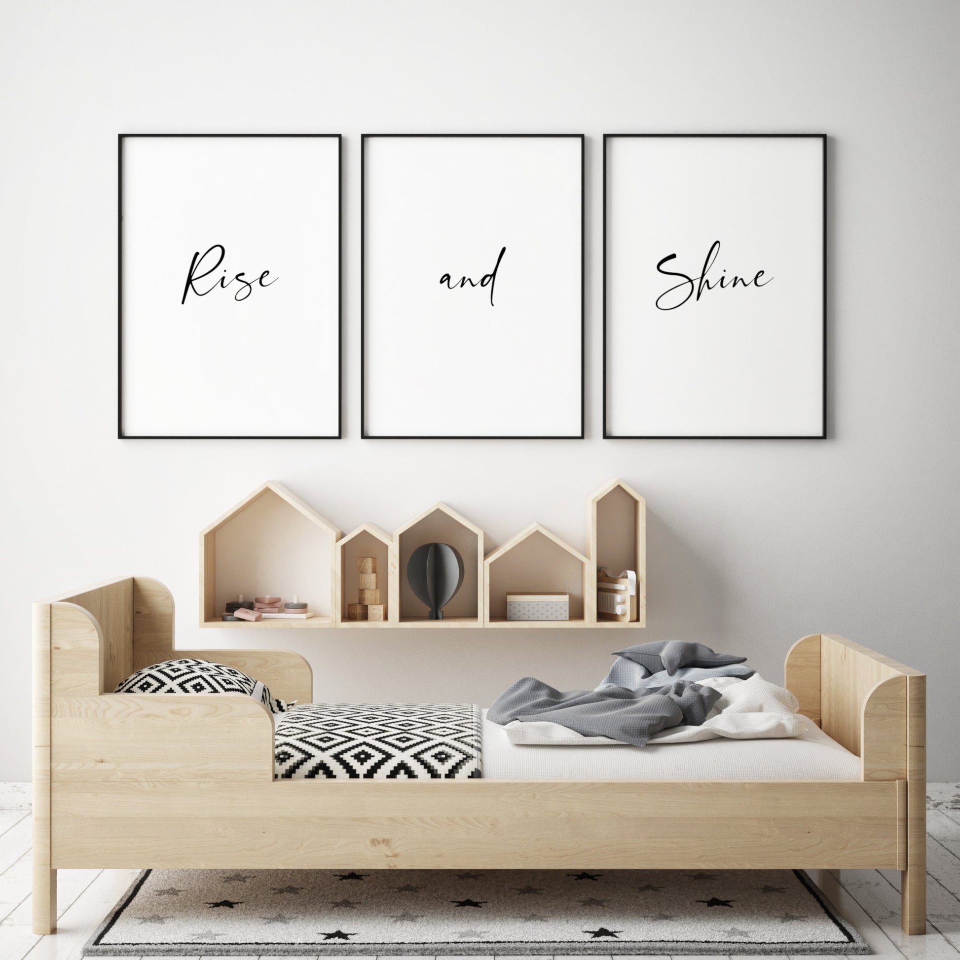 Set of 3 typography posters shown in a nursery or child's bedroom setting. Text across the three reads: rise and shine. The entire quote is in a bright and elegant script font. Text is black on a white background.