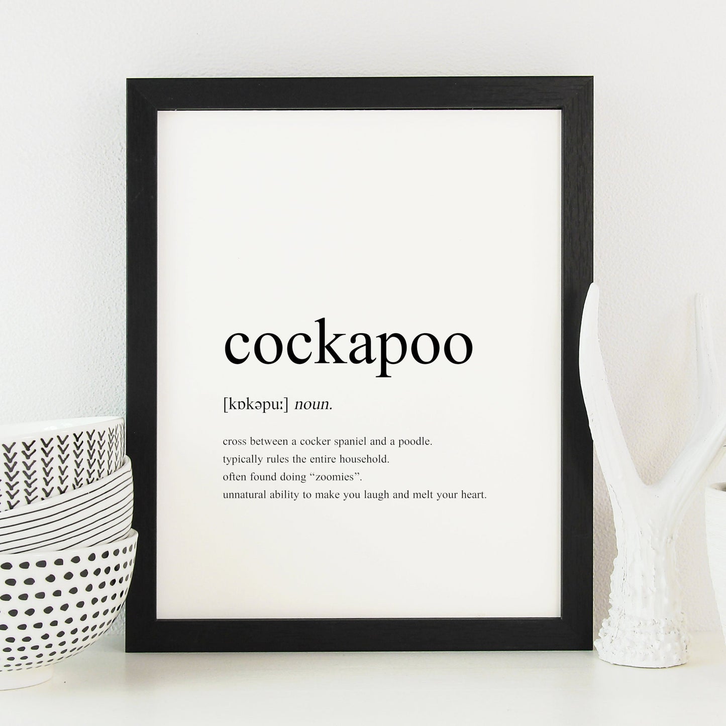 Cockapoo definition print displayed in a black frame. Styled as per a traditional dictionary definition, including the pronunciation and description. Text is factual, fun and sentimental about cockapoos. See the product description for the full text.