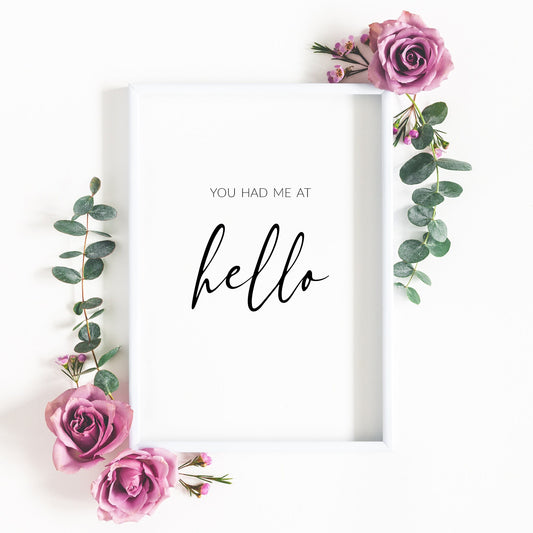 Single portrait typography print. Quote reads: You had me at hello. The word hello is displayed prominently in an elegant script font. Text is black on a white background. Perfect Valentine's Day gift.