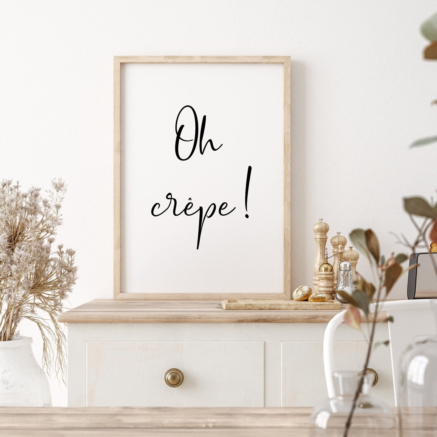 Single portrait typography print displayed in a kitchen setting. The text reads: Oh crêpe! The quote is displayed in a fun handwritten font that captures the essence of the quote.