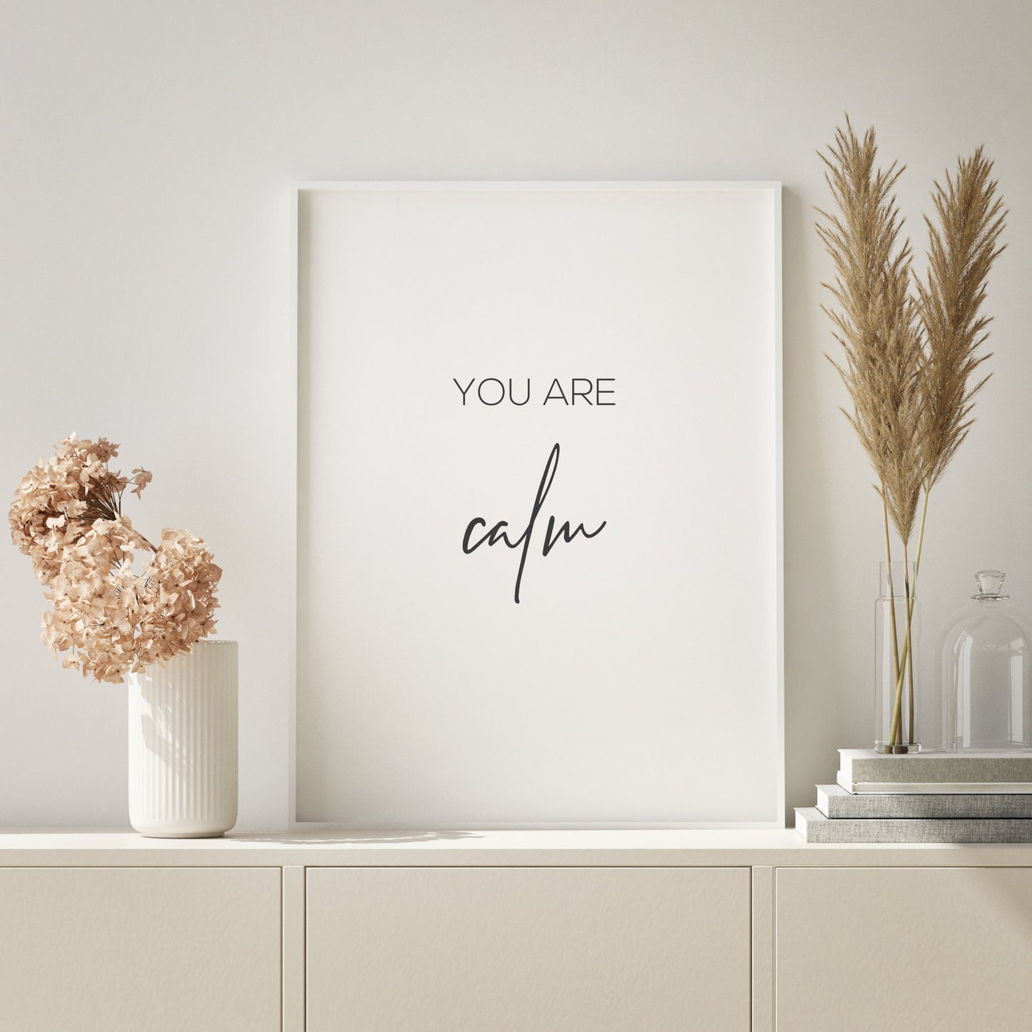 Single portrait typography print. Text reads: You are calm. The word calm is positioned prominently in an elegant script font. Text is black on a white background.