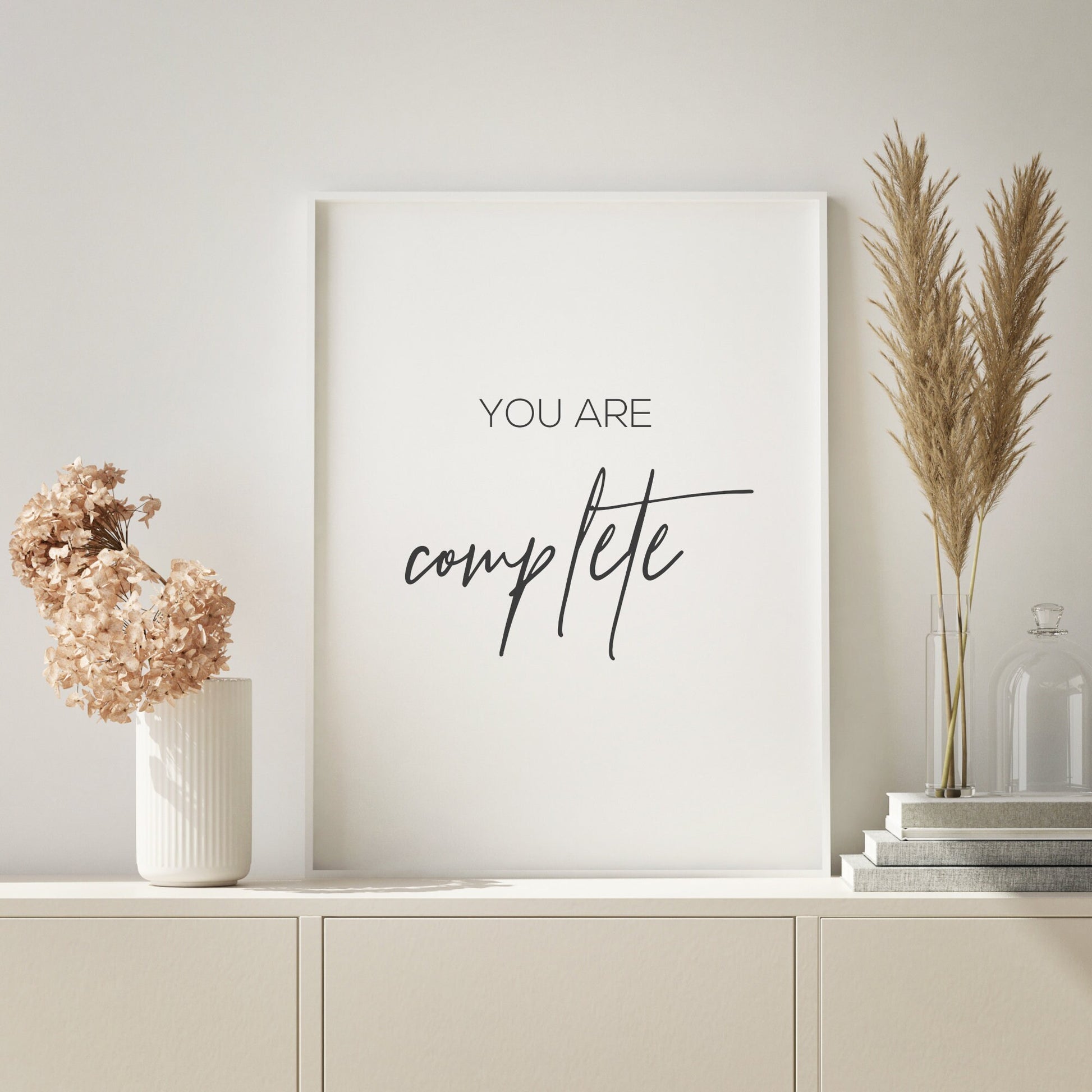 Single portrait typography print. Text reads: You are complete. The word complete is displayed prominently in an elegant script font. Text is black on a white background.