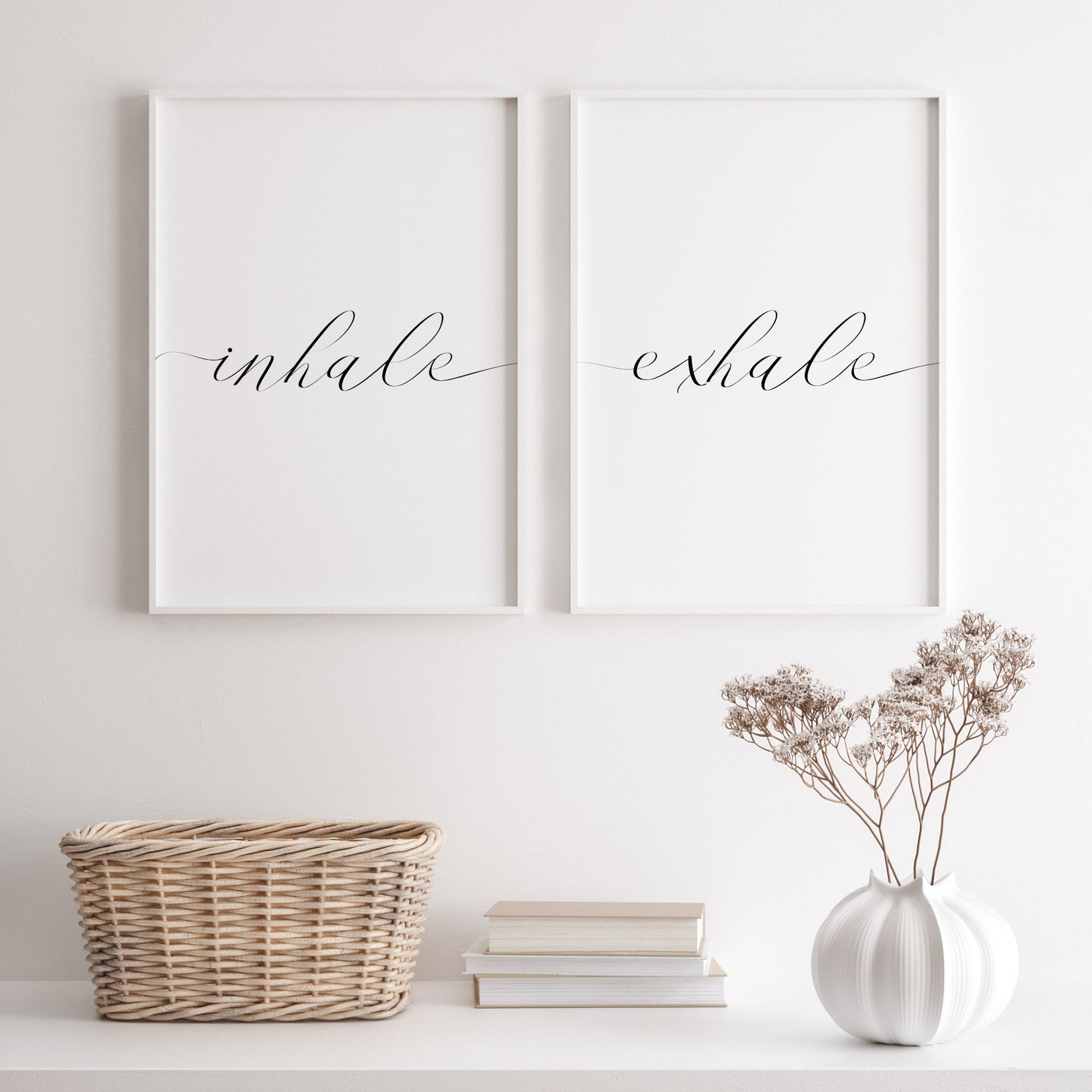 Set of 2 typography prints featuring the words inhale and exhale. An elegant script font is used for both, with the edges of each word trailing towards the outer edges of the prints. Text is black on a white background.