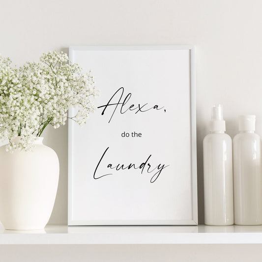 Single portrait typography print. Text reads: Alexa, do the laundry. The words Alexa and Laundry are positioned prominently in an elegant script font, with the other words in a small sans serif font. Text is black on a white background.