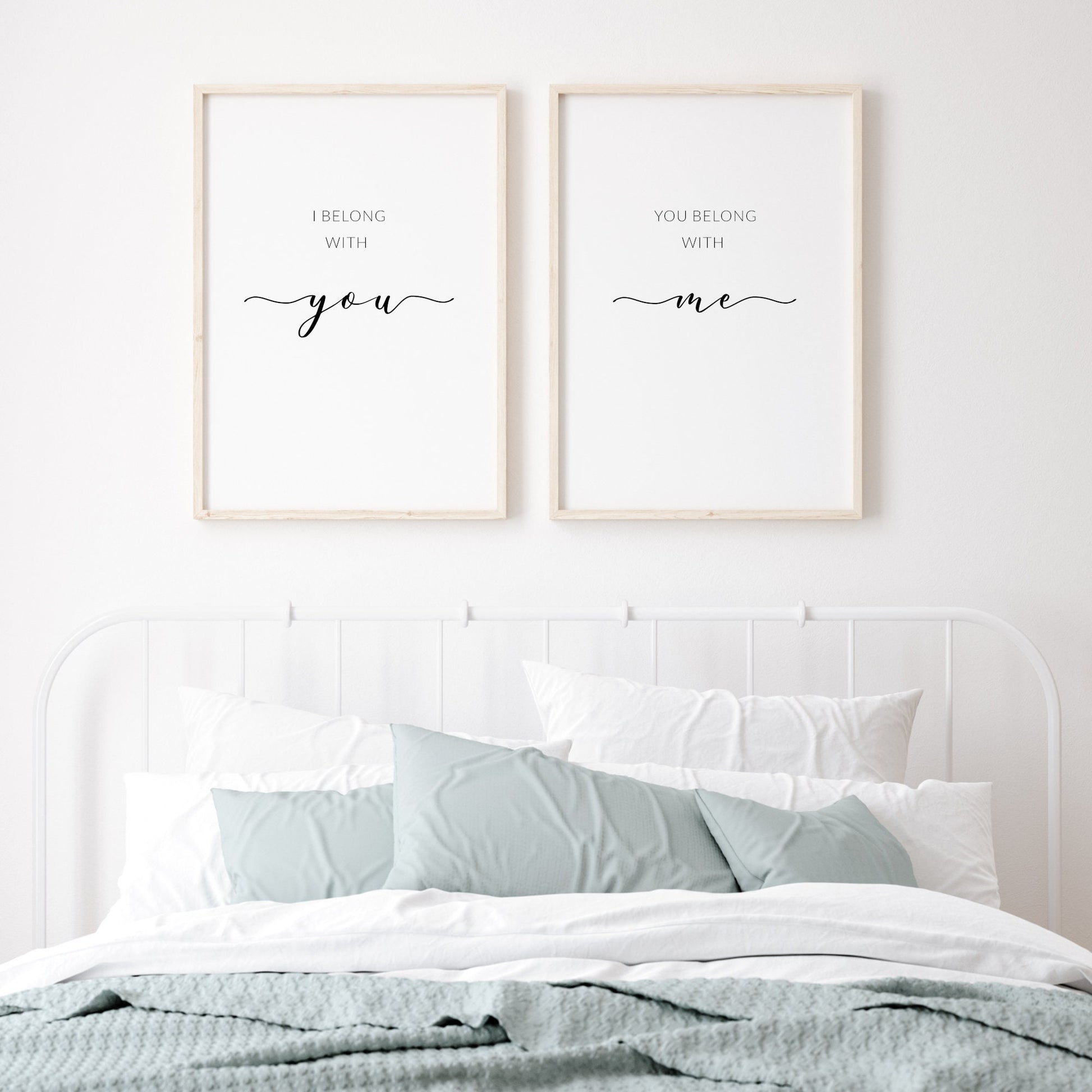 Set of 2 portrait quote prints. Print 1 reads: I belong with you. Print 2 reads: You belong with me. The words you and me are prominent and in an elegant script font. Remaining text is in a small upper case sans serif font. Text is black. 