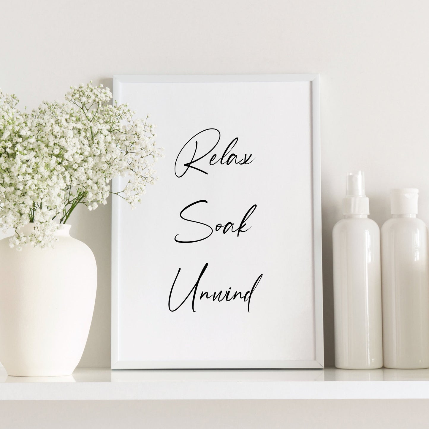 Single portrait typography print for the bathroom. Text reads: Relax Soak Unwind. The words are stacked vertically and centred, with a bold script font used. The perfect gift for anyone who loves a bubble bath!