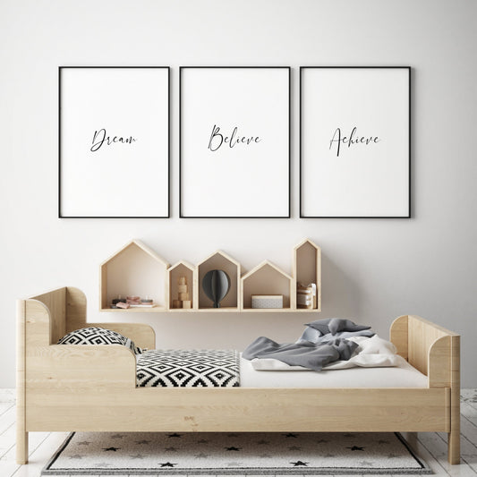 Set of 3 portrait typography prints shown in a child's bedroom setting.  Print 1 text reads: Dream. Print 2 text reads: Believe. Print 2 text reads: Achieve. The text is displayed prominently in each of the prints, in an elegant script font.