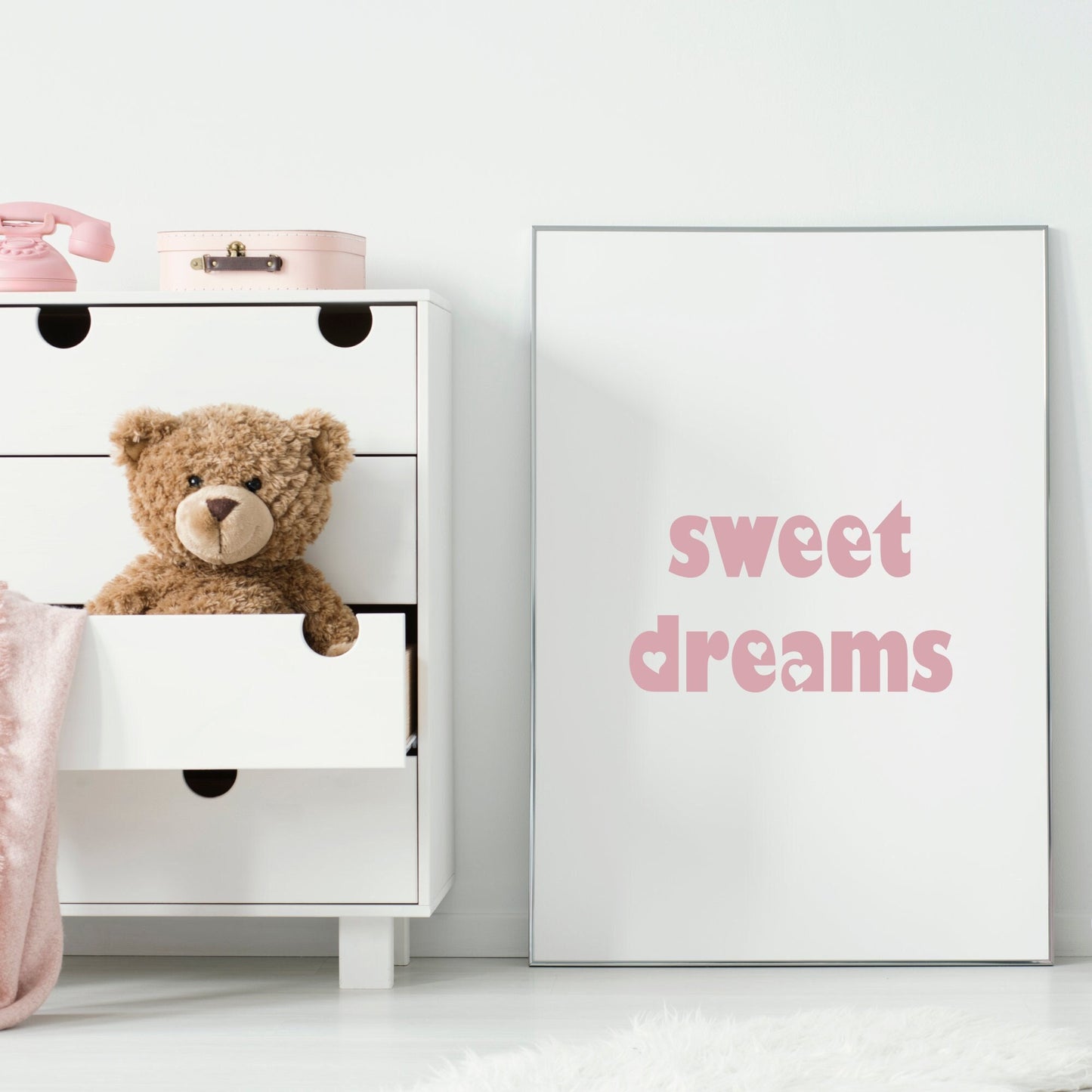 Single portrait print, with the words "Sweet Dreams". Text is pink on a white background and in a playful font, where the holes in letters have been replaced with hearts. The perfect accessory for your baby's nursery.