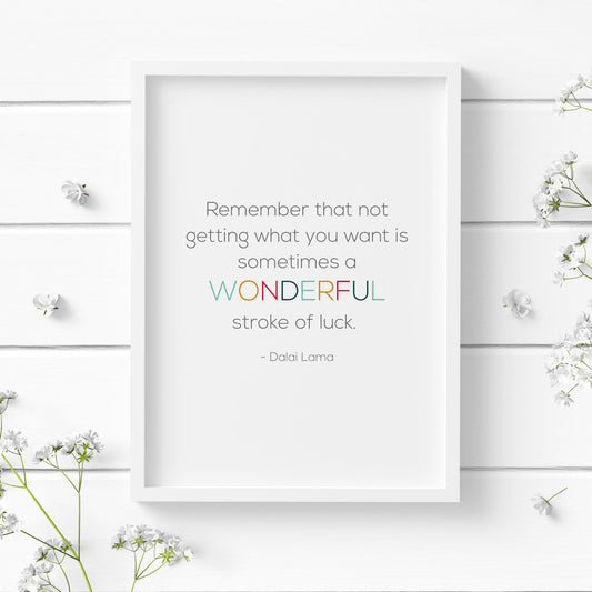 Single portrait typography print. Text reads: Remember that not getting what you want is sometimes a wonderful stroke of luck. This is followed by an attribution to Dalai Lama. The word wonderful is highlighted in multicolour.