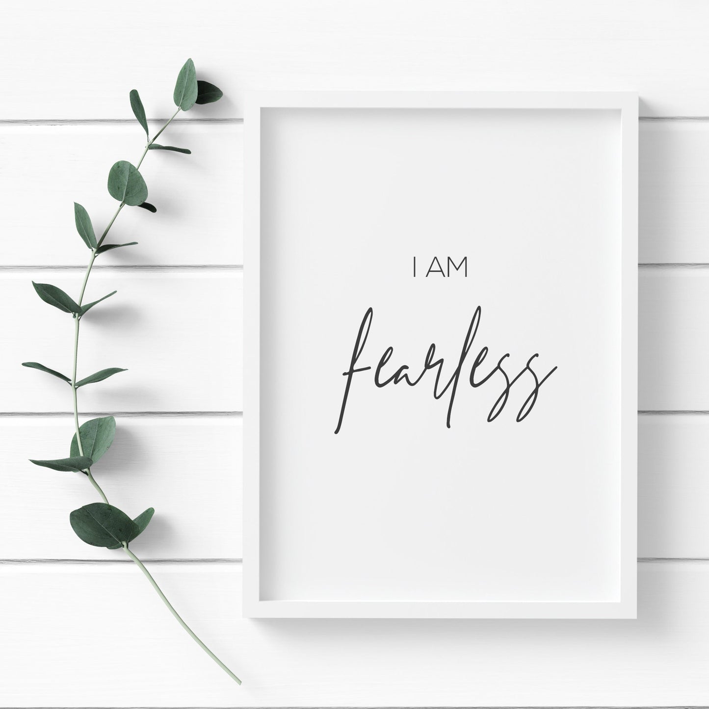 Single portrait typography print. Text reads: I am fearless. The word fearless is positioned prominently in an elegant script font. Text is black on a white background.