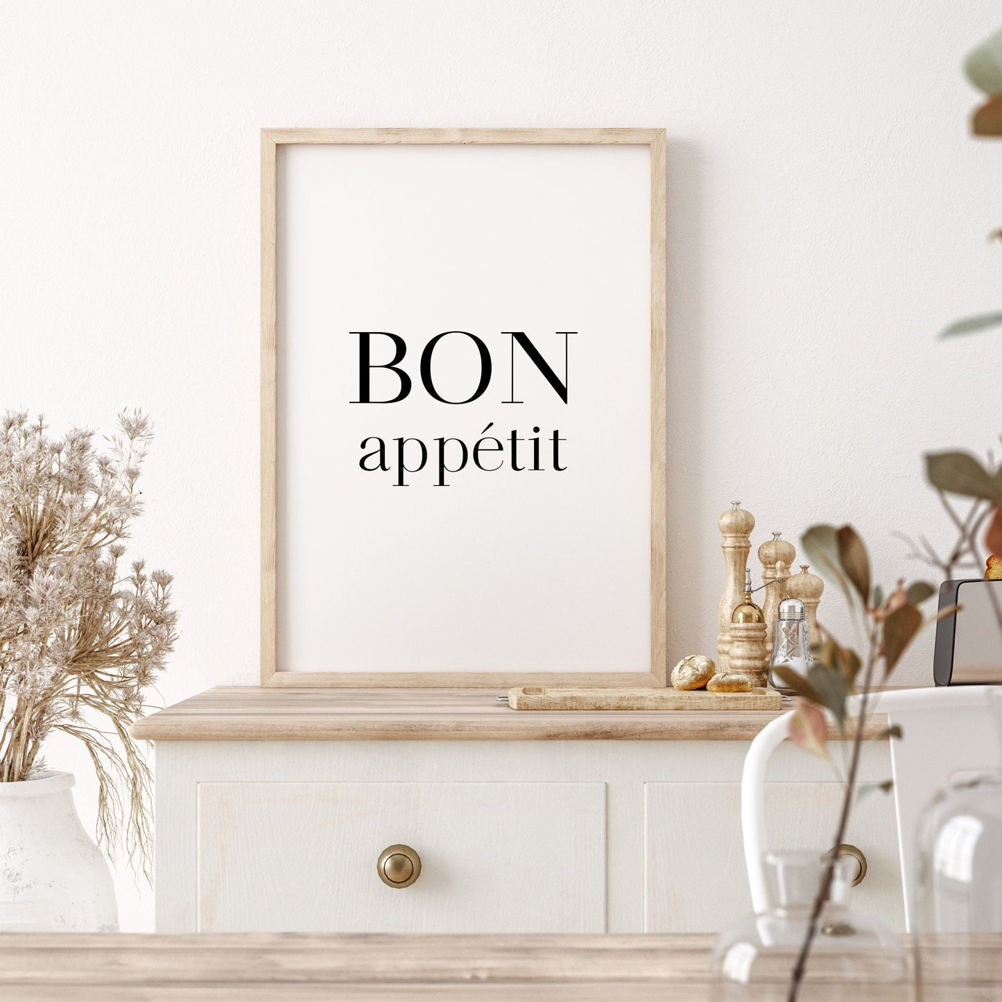 Single portrait typography print for the kitchen or dining room. Text reads: Bon appetit. The words are stacked vertically, with Bon in upper case and appetit in lower case. The formal serif font has been sized so both words have the same width.